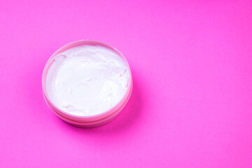 Beauty cream jar on pink background