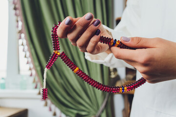 Religious Asian buddhist woman praying with hand holding rosary beads. Female buddhist disciple...