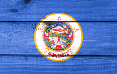 minnesota flag painted on old wood plank background. Brushed natural light knotted wooden board texture. Wooden texture background flag of minnesota