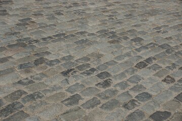 Stone gray texture from a fragment of a old pavement with cobblestones in the street