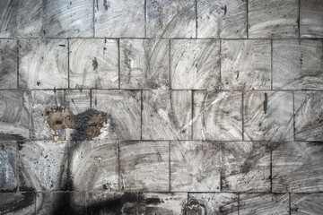 Abstract grunge background. Dirty tiles on the wall with blurry traces of soot and dust. Gray...