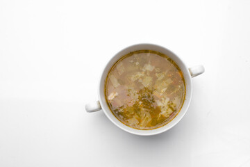 Green Sorrel soup with Boiled meat On a White Table, Horizontal top view