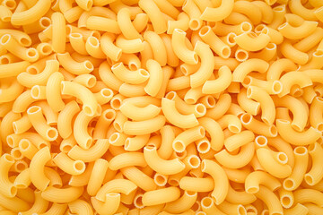 Uncooked pasta cornetti background, texture