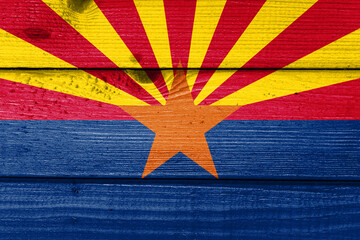 arizona flag painted on old wood plank background. Brushed natural light knotted wooden board...