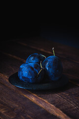 plums on a wooden table