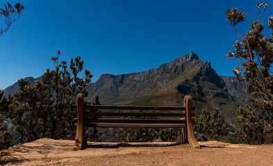One empty bench with Table Mountain view on background