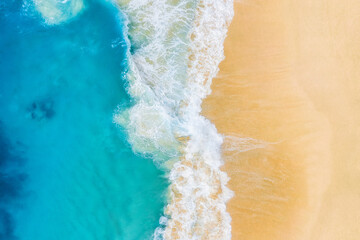 Beach and large ocean waves. Coast as a background from top view. Blue water background from drone. Summer seascape from air. Travel image
