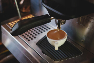  Barista prepares to make coffee with a coffee machine.