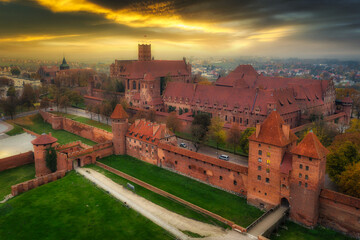 Misty sunrise over the Malbork castle and Nogat river in Poland