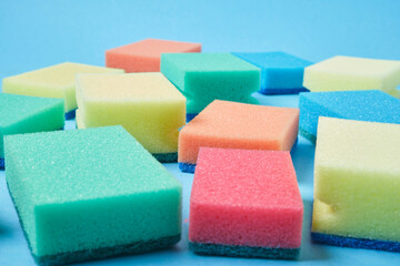 New colorful sponges for washing dishes on blue background