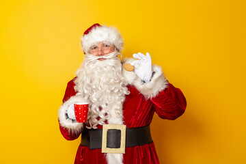 Santa Claus drinking milk and eating Christmas cookies