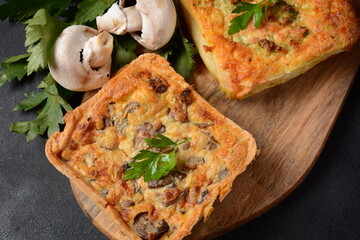 Homemade quiche or pie with  broccoli, seasonings, champignons and cheese on a gray background.