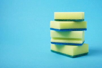 some yellow dishwashing sponges on blue background