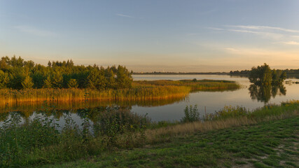 Late afternoon panoramic landscape at Pogoria IV Lake.