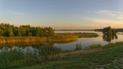 Late afternoon panoramic landscape at Pogoria IV Lake.