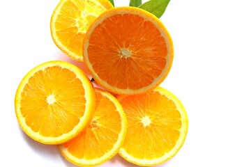 Orange fruit piece slices with green leaves fruits or vegetables isolated on white background closeup.
