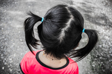 Closeup Hair binding or Hair tie of the little girl from behind