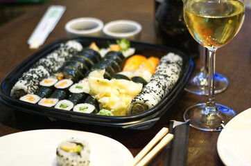 Sushi dinner with white wine with elegant white plates.