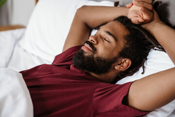 Fototapeta na wymiar Tired young african-american man sleeping