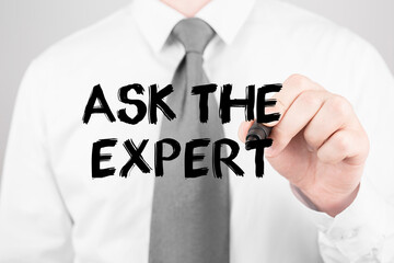 Businessman writing word ASK THE EXPERT with marker, Business concept