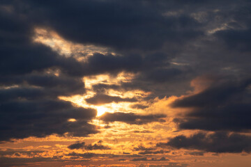Obraz premium Dramatic dark sky and orange sunset color. Contrast blurred natural background.