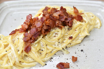 Close-up view, Spaghetti carbonara with crispy bacon.