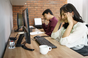 Portrait of frustrated asian female workers. Having hard work in the office