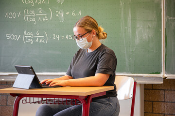 student learning in classroom during corona times