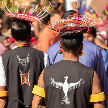 Abstract rear portrait of Naga men wearing traditional headgear made of straw
