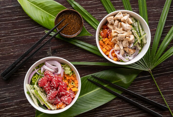 Variety of healthy organic poke bowls with tuna, chicken, tofu and cucumber, rice, carrots, onion...
