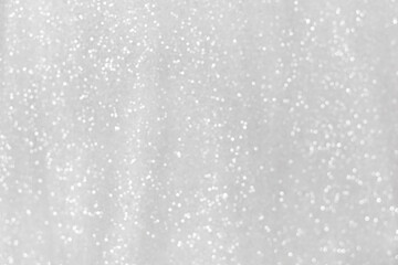 silver Sparkling Lights Festive background with texture. Abstract Christmas twinkled bright bokeh defocused and Falling stars.