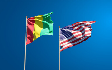 Beautiful national state flags of Guinea and USA together at the sky background. 3D artwork concept.