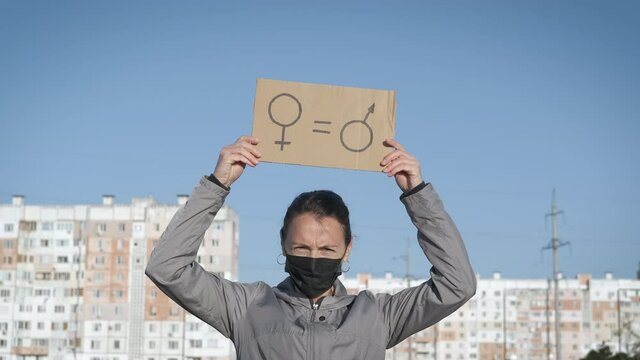 Women's rights. Woman need rights. Woman with a poster of equality between women and men.