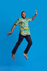 Smiling african american guy having fun, wearing traditional clothes