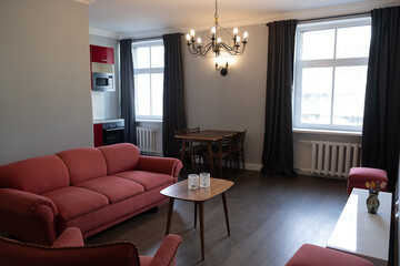 Modern fresh renovation of classical living room with antique and retro furniture. Classic apartment internal design in Europe city center urban area.