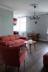 Modern fresh renovation of classical living room with antique and retro furniture. Classic apartment internal design in Europe city center urban area.