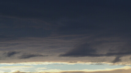 Belle lumière jaunâtre se répercutant sous la base d'un gros cumulus