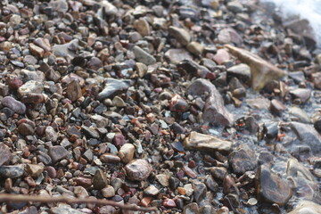 Sea pebble stones by the sea.A pile of smooth little stones background/ 