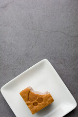 Top view a square-cut of sweet potato cake on a white plate in the kitchen. Bakery and beverage concept.