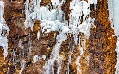 Icicles of ice from falling water in winter