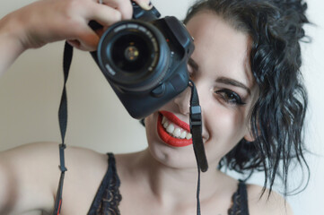 Beautiful young woman taking pictures with the camera close up portrait	
