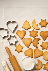 Christmas homemade gingerbread cookies on a white table top view.   Festive homemade gingerbread cookies. Christmas time. Traditional Christmas cookies