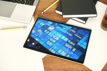 Modern digital tablet monitor with abstract creative statistics data hologram, statistics and analytics concept. Top view. 3D Rendering