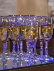Glass glasses with champagne close up on the bar in a cafe