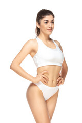 Fototapeta premium Confident. Beautiful female model on white background. Beauty, cosmetics, spa, depilation, diet and treatment, fitness concept. Fit and sportive, sensual body with well-kept skin in underwear.