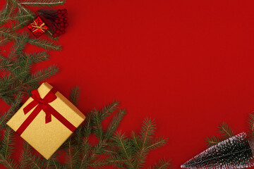 Frame of Christmas decorations on a red background.Flatly, CopySpace