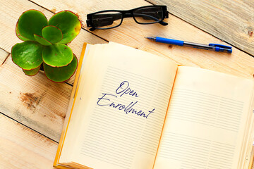 Fototapeta premium OPEN ENROLLMENT text written in a notebook