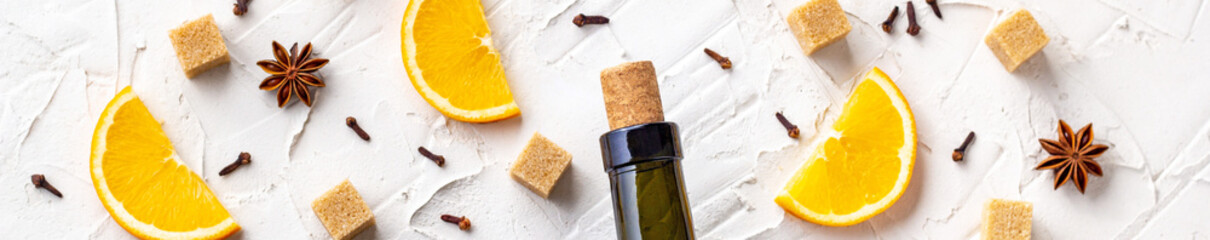 border ofBottle of wine, orange, sugar, cinnamon sticks, anise and fir branches
