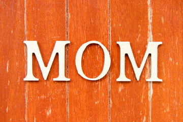 Alphabet letter in word mom on old red color wood plate background