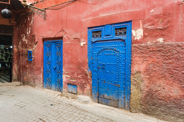 Passage in Medina with orange walls and blue doors